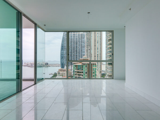 Image of living room with windows with views of th city and skyline in this condo for sale in Pacific Point