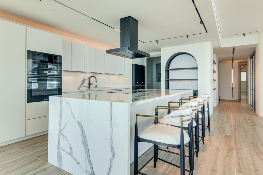 Image of kitchen with breakfast bar and chairs in this condo for sale in Pacific Point
