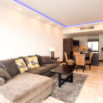 Image of living dining area with couch, table, and dining table and chairs in this condo for sale in JW Marriott