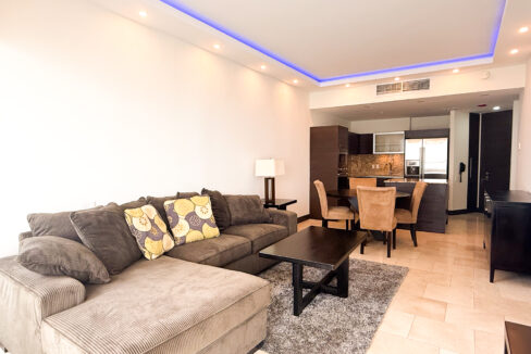 Image of living dining area with couch, table, and dining table and chairs in this condo for sale in JW Marriott