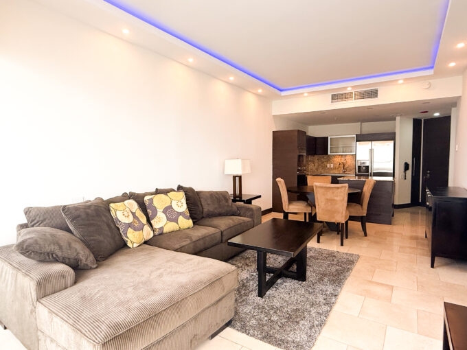Image of living dining area with couch, table, and dining table and chairs in this condo for sale in JW Marriott