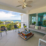 Image of terrace with balcony, table and chairs in this Ocean-View Condo for sale in Bijao