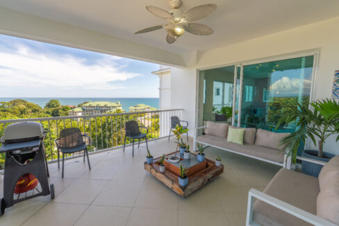Image of terrace with balcony, table and chairs in this Ocean-View Condo for sale in Bijao