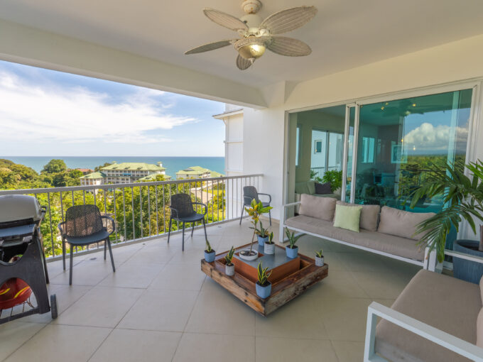 Image of terrace with balcony, table and chairs in this Ocean-View Condo for sale in Bijao
