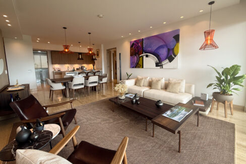 Image of living area with couch, table and dining space in this condo for sale in Celeste