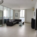 Image of living area with couch and windows in this cozy condo for sale in Quadrat