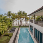 Image of swimming pool and beach at this Beachfront home for sale