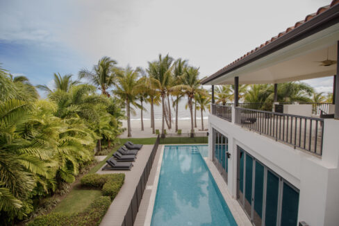 Image of swimming pool and beach at this Beachfront home for sale