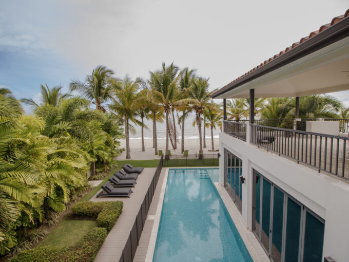 Image of swimming pool and beach at this Beachfront home for sale