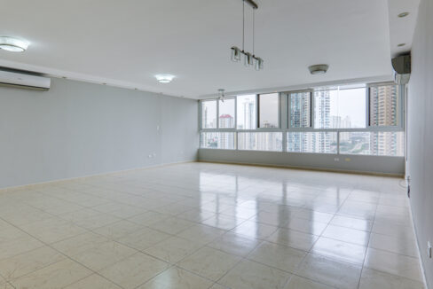 Image of living area with multiple windos in this condo for rent in Pacific Star
