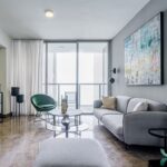Image of living area with couch, chair and table in this High-Floor Condo for Rent in YOO Tower
