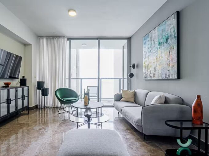 Image of living area with couch, chair and table in this High-Floor Condo for Rent in YOO Tower