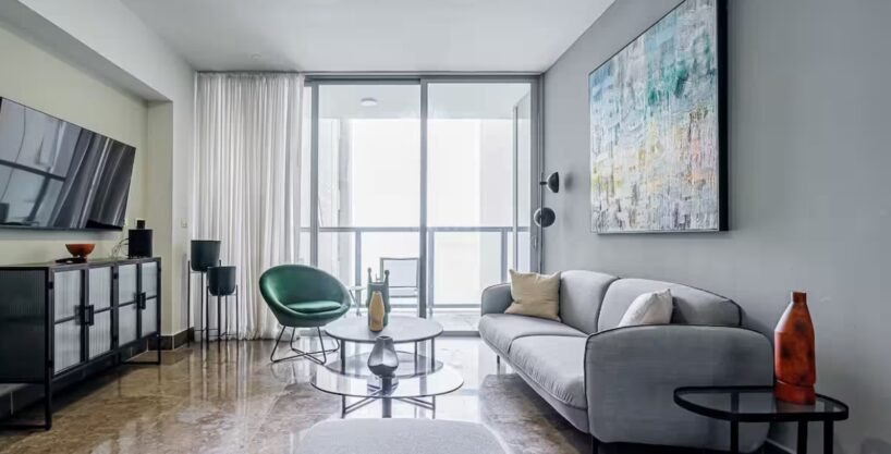 Image of living area with couch, chair and table in this High-Floor Condo for Rent in YOO Tower