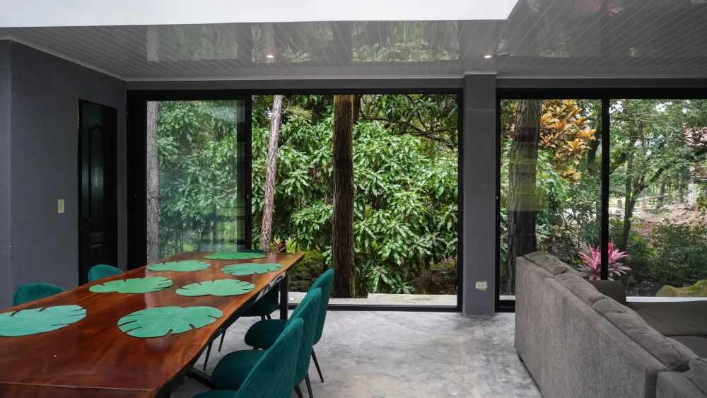 Modern mountain home interior with forest view highlighting cooler climates and outdoor living by Panama Equity Real Estate