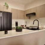 Image of kitchen with refrigerator and countertop in this Model F Two Bedroom Condo in Aura Obarrio