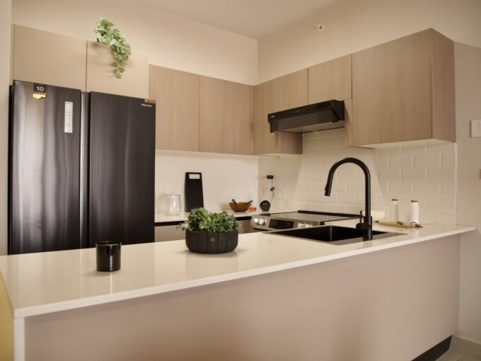 Image of kitchen with refrigerator and countertop in this Model F Two Bedroom Condo in Aura Obarrio