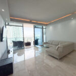 Image of living area with furniture and balcony in this condo for sale in Grand Tower