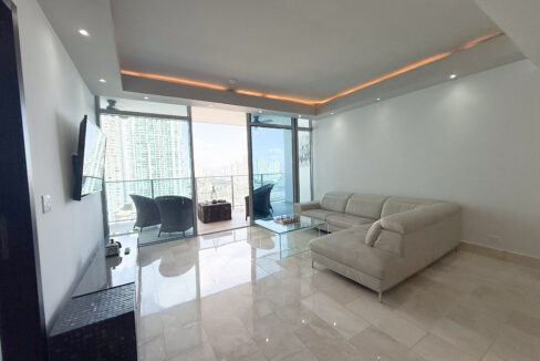 Image of living area with furniture and balcony in this condo for sale in Grand Tower