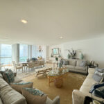 Image of living area with couches, table and chairs in this spacious condo for sale in Allure at the Park