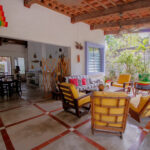 Image of terrace with table and multiple chairs in this house for sale in Togo Farallon