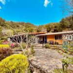 Outside of this mountain home for sale in Toscana