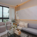 Image of living area with couch and two chairs in this condo for sale in Aquapoint