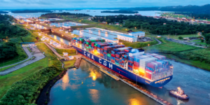 Cargo ship transiting the Panama Canal with stacked containers