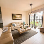 Image of living space with couch and table in this condo for sale in Embassy Village