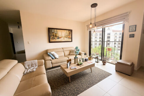 Image of living space with couch and table in this condo for sale in Embassy Village