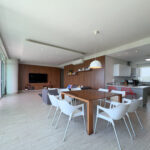 Image of living room with table and chairs in this condo for sale in Punta Barco