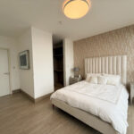 Image of bedroom with bed and table in this condo for sale in Balcony