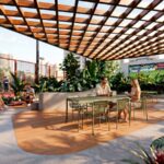 Covered social area with greenery and seating in Vibe