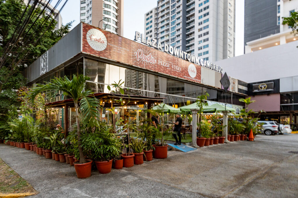 Outdoor dining plaza with restaurants and potted plants in El Cangrejo Panama City real estate services by Panama Equity Real Estate