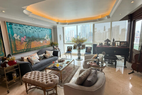 Main living area with furniture and ocean views in this condo for sale in P.H Peninsula