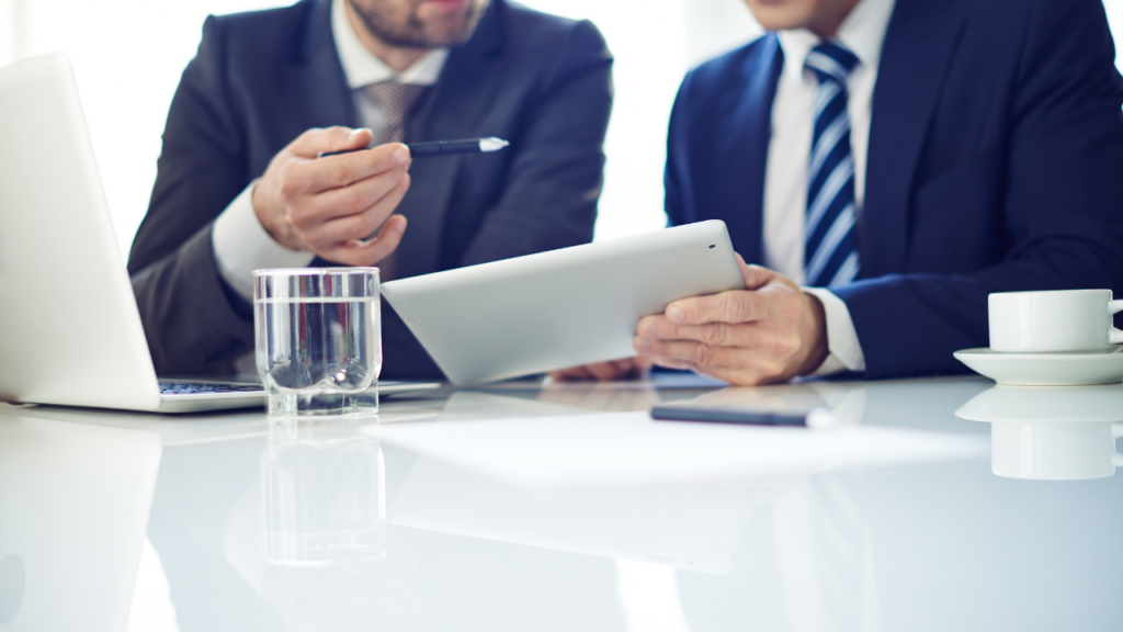 Business professionals reviewing documents on a digital tablet to learn how to work in Panama real estate services in Panamá by Panama Equity Real Estate