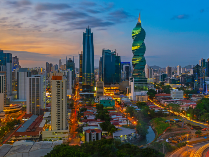 Illuminated city skyline featuring the F&F Tower at twilight highlighting how to work in Panama real estate services in Panamá by Panama Equity Real Estate