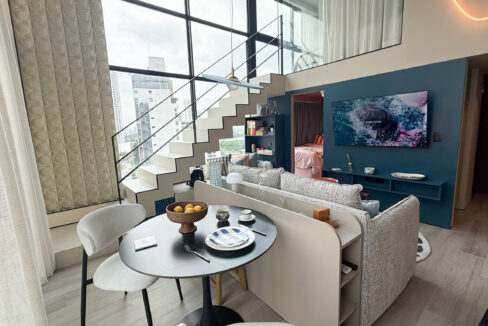 Large living space with furniture in this condo for sale in Dovle Selva