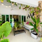 Beautiful terrace with plants and furniture in this home for sale in Punta Barco Village