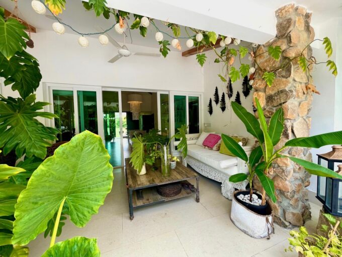 Beautiful terrace with plants and furniture in this home for sale in Punta Barco Village