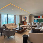 Living room with furniture and wraparound balcony in this condo in Allure