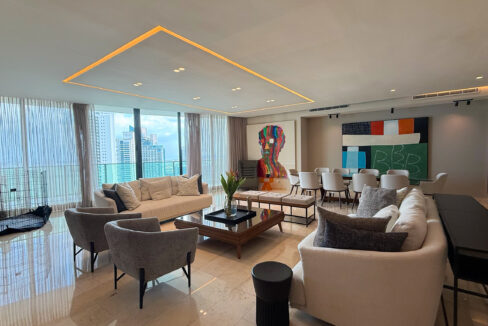 Living room with furniture and wraparound balcony in this condo in Allure
