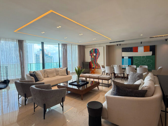 Living room with furniture and wraparound balcony in this condo in Allure