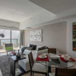 Living room with balcony and ocean views in this condo for rent in The Ocean Club