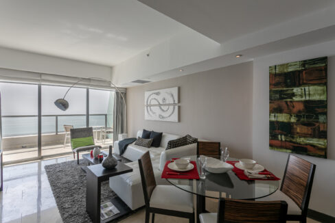 Living room with balcony and ocean views in this condo for rent in The Ocean Club