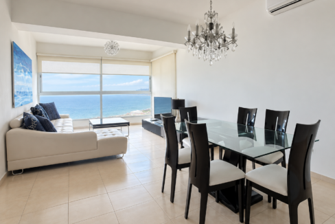 Furnished living and dining area with Bay of Panama views at Vista del Mar 25B