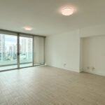 Living room with balcony and city views in Harmony Tower