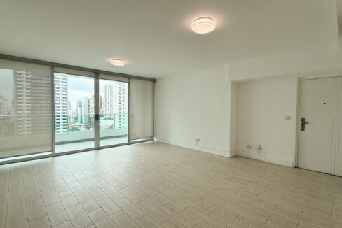 Living room with balcony and city views in Harmony Tower