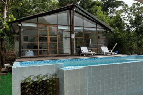 Front of a Taboga house for sale with infinity pool and deck